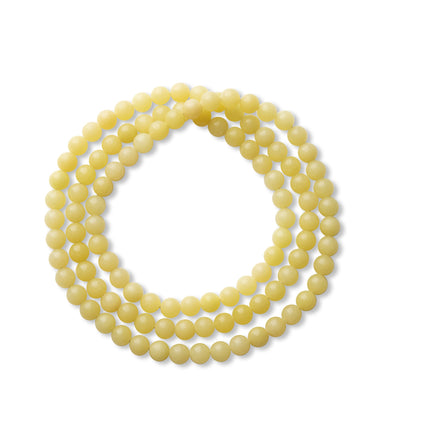 Fine-bead stacking bracelet on white background