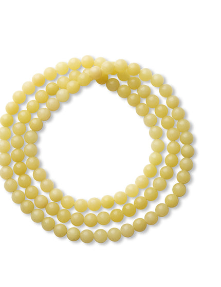 Fine-bead stacking bracelet on white background